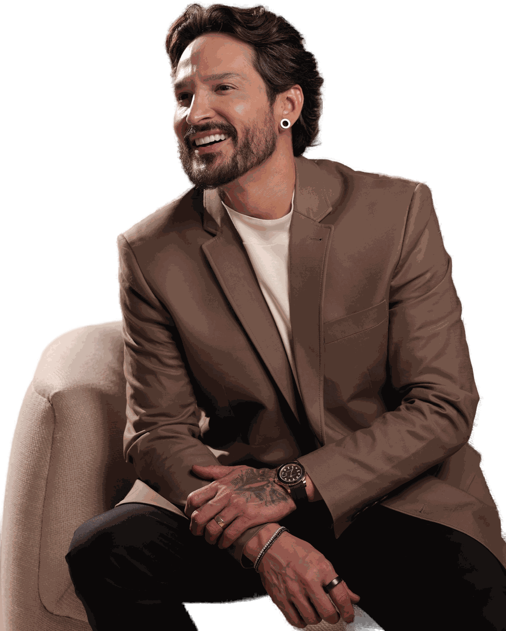 Robson Souza sentado, de blazer marrom, durante entrevista.